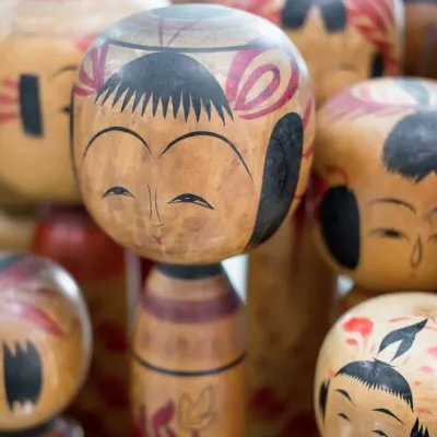 Collection of Kokeshi dolls of various sizes.